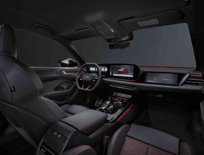 Gedetailleerd interieur van de Audi RS5, met zwarte lederen stoelen en sportieve rode stiksels.
