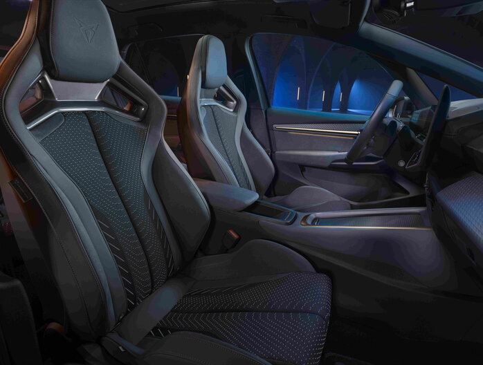 Cupra Born interieur toont sportieve donkere stoelen, modern dashboard en blauwe sfeerverlichting.