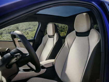 Interieur van blauwe Volkswagen ID.Polo met lichte stoelen en open panoramadak.