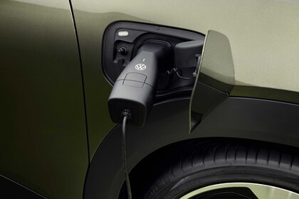 Volkswagen ID. Cross wordt opgeladen, laadstekker in de poort van de elektrische auto.